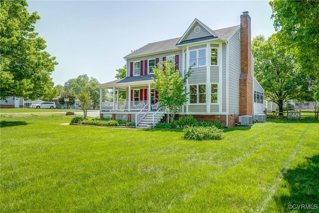 back of property with a porch, a lawn, a chimney, and cooling unit