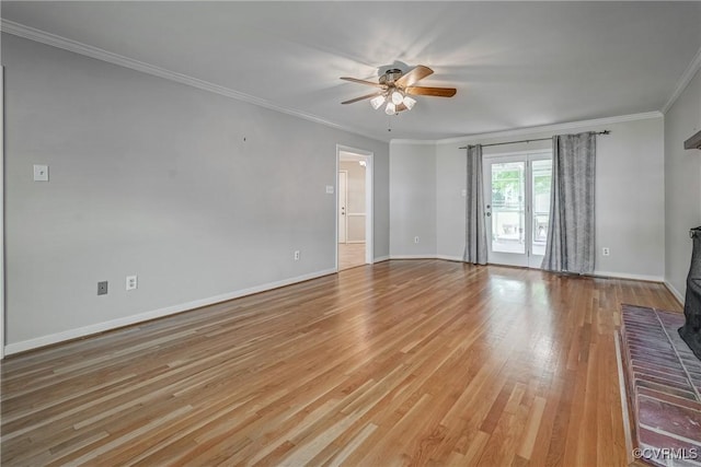 empty room with crown molding, ceiling fan, baseboards, and light wood-style flooring