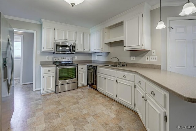 kitchen with a sink, stone finish flooring, appliances with stainless steel finishes, and white cabinets