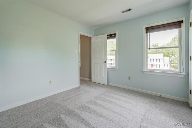unfurnished bedroom with visible vents, carpet, and baseboards