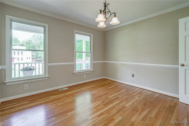 spare room featuring baseboards, light wood-style flooring, and visible vents