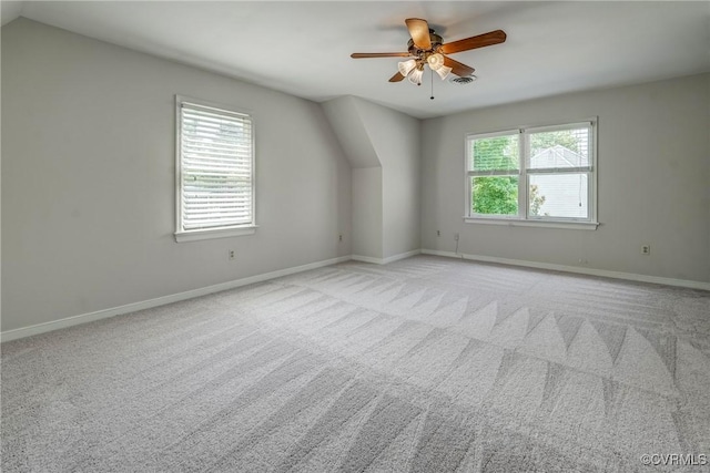 bonus room with a ceiling fan, baseboards, light colored carpet, and visible vents