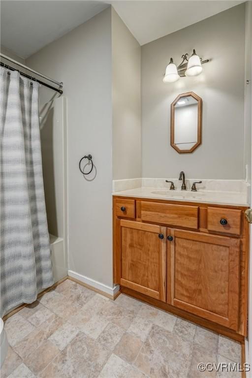 bathroom with vanity and baseboards