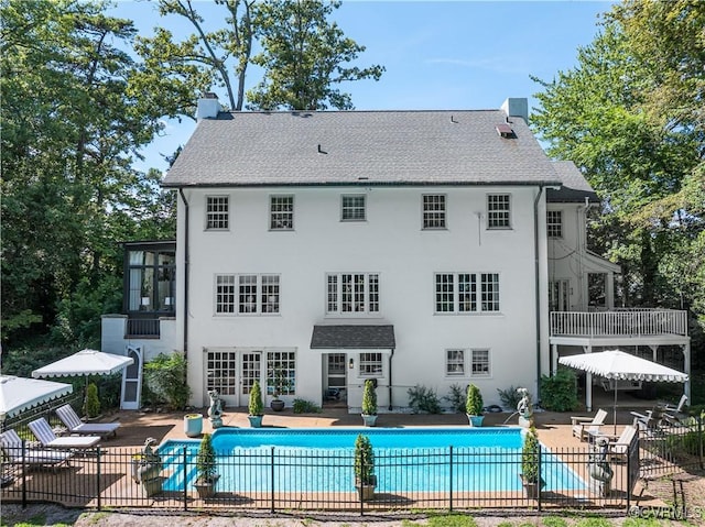 7 River Rd, Richmond, VA 23226 - rear view of property featuring a chimney, a patio area, an outdoor pool, and stucco siding