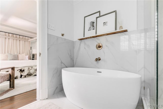7 River Rd, Richmond, VA 23226 - bathroom featuring tile walls, a freestanding tub, ensuite bathroom, crown molding, and wainscoting