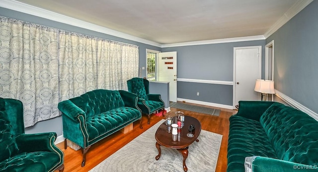 living room with crown molding, baseboards, and wood finished floors