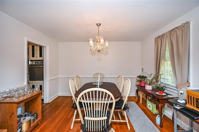 dining room featuring a notable chandelier and wood finished floors