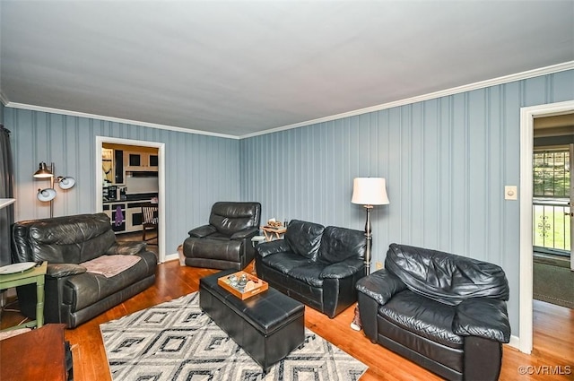 living area featuring crown molding and wood finished floors