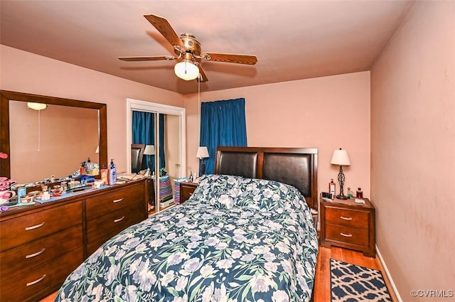 bedroom featuring baseboards, a ceiling fan, and wood finished floors