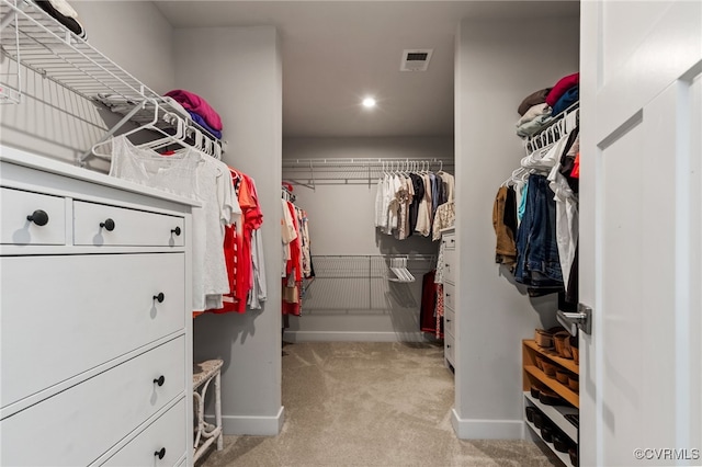 spacious closet with visible vents and light colored carpet