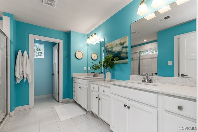bathroom with visible vents, a shower stall, tile patterned flooring, and vanity