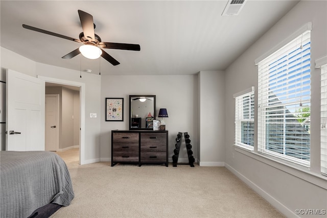 bedroom featuring baseboards, multiple windows, light carpet, and visible vents