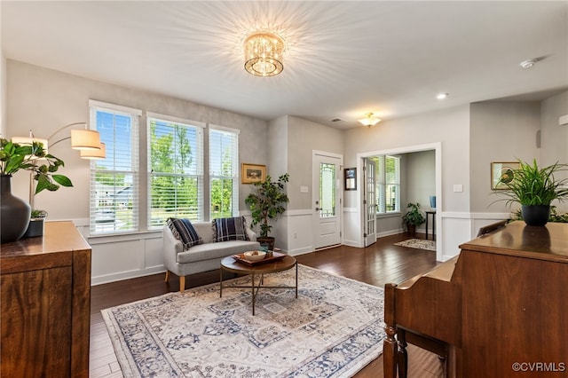 living room with recessed lighting, a notable chandelier, and dark wood-style floors