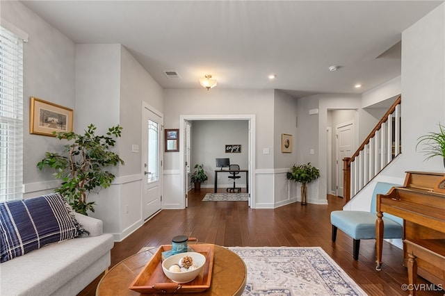 living area with visible vents, stairs, baseboards, wood-type flooring, and recessed lighting
