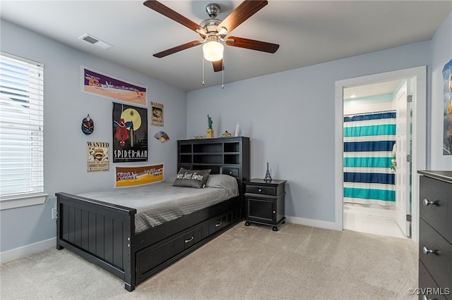 bedroom featuring visible vents, carpet, and multiple windows