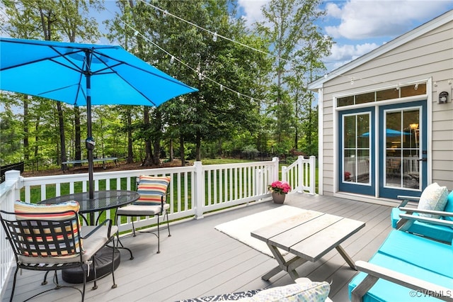 deck featuring outdoor dining area