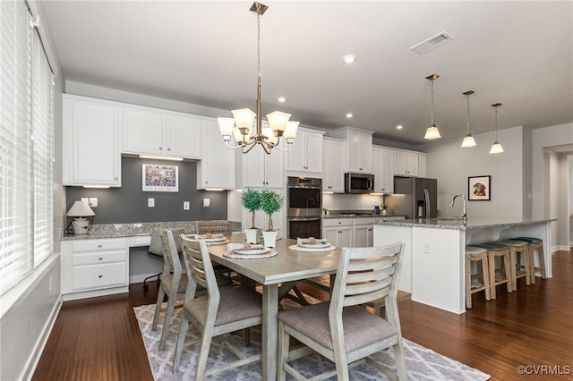 dining room featuring visible vents, baseboards, dark wood-style floors, and an inviting chandelier