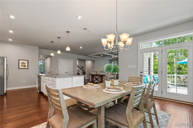 dining space featuring visible vents, baseboards, dark wood-style floors, recessed lighting, and a notable chandelier