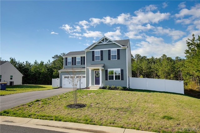 traditional-style home with board and batten siding, driveway, a front yard, fence, and an attached garage