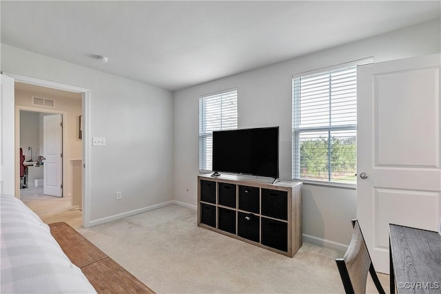 bedroom featuring baseboards, multiple windows, light carpet, and visible vents