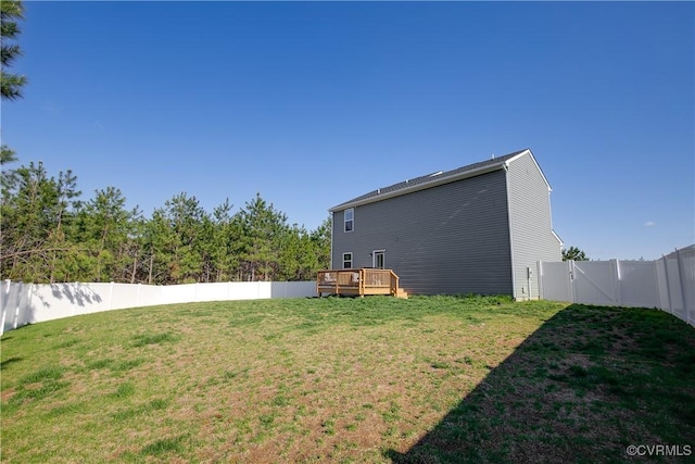 view of yard featuring a wooden deck and a fenced backyard