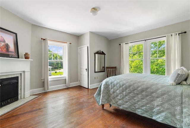 510 Cedar Ln, Hopewell, VA 23860 - bedroom featuring baseboards, hardwood / wood-style flooring, and a fireplace with flush hearth