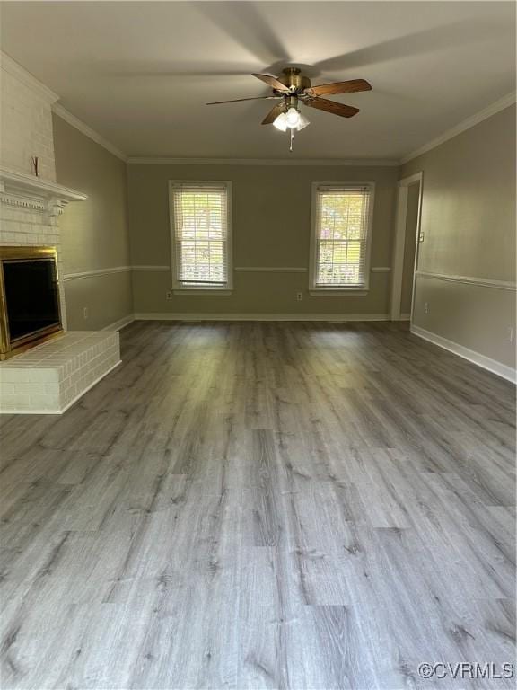 1916 Boardman Ln, Henrico, VA 23238 - unfurnished living room with plenty of natural light, a ceiling fan, crown molding, wood finished floors, and a fireplace