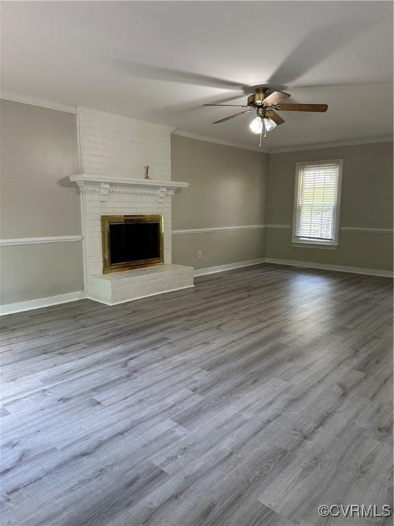 1916 Boardman Ln, Henrico, VA 23238 - unfurnished living room with crown molding, a ceiling fan, wood finished floors, baseboards, and a brick fireplace