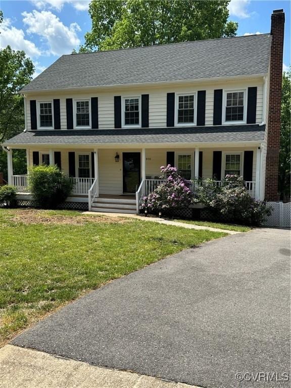 1916 Boardman Ln, Henrico, VA 23238 - colonial house featuring a chimney, a porch, and a front lawn