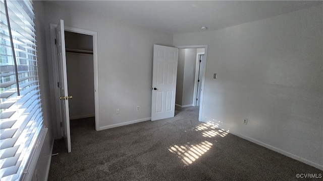 1916 Boardman Ln, Henrico, VA 23238 - unfurnished bedroom with carpet flooring, a closet, baseboards, and a walk in closet