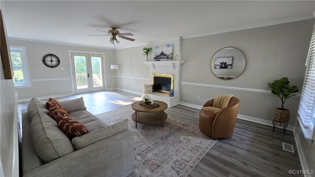 1916 Boardman Ln, Henrico, VA 23238 - living area featuring a ceiling fan, wood finished floors, a brick fireplace, french doors, and crown molding