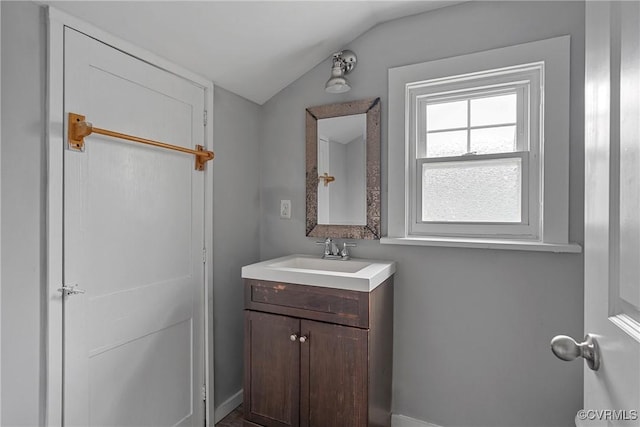 bathroom with vanity and vaulted ceiling