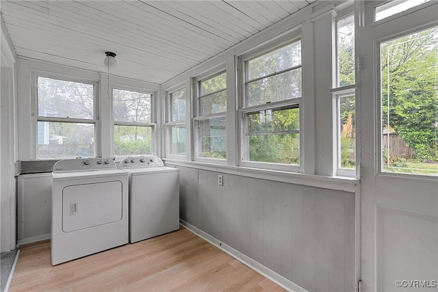 washroom with independent washer and dryer, laundry area, a healthy amount of sunlight, and light wood-type flooring
