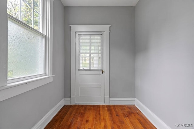 entryway with baseboards and wood finished floors