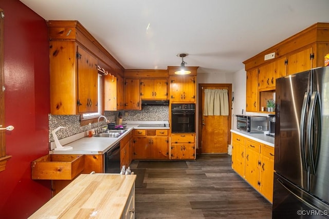 400 E California Ave, Crewe, VA 23930 - kitchen with dark wood-style flooring, a sink, light countertops, decorative backsplash, and black appliances