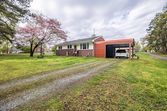 400 E California Ave, Crewe, VA 23930 - view of front facade with brick siding, an attached carport, driveway, and a front yard