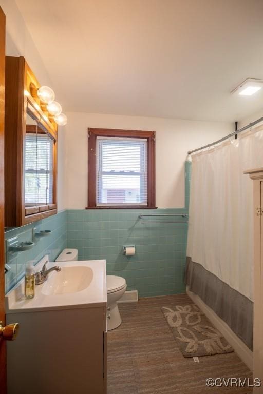 400 E California Ave, Crewe, VA 23930 - bathroom featuring wainscoting, tile walls, vanity, and toilet