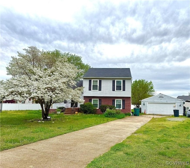 tri-level home with a garage, a front lawn, fence, brick siding, and an outbuilding