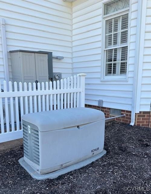 exterior details with electric meter, a power unit, fence, and crawl space