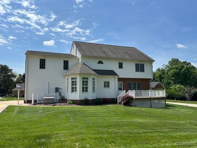 back of house featuring a yard, a deck, and cooling unit