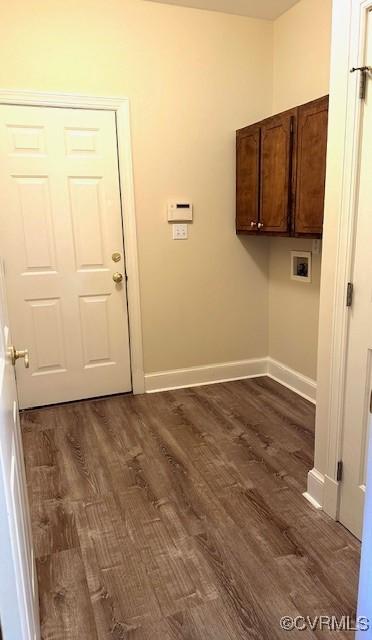 clothes washing area featuring cabinet space, dark wood-style flooring, baseboards, and hookup for a washing machine
