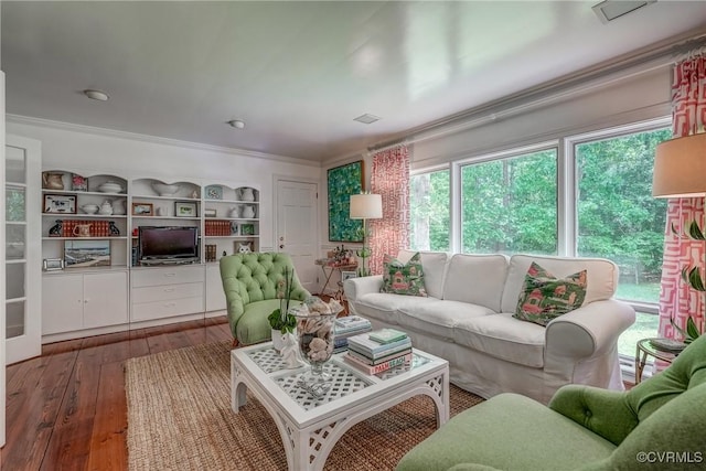 living area featuring hardwood / wood-style flooring and crown molding