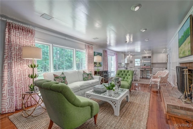 living area with a fireplace, hardwood / wood-style floors, and recessed lighting