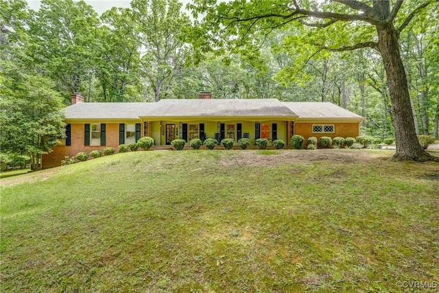 single story home with a chimney and a front lawn