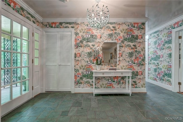 unfurnished dining area featuring wallpapered walls, baseboards, stone tile floors, a chandelier, and ornamental molding