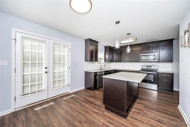 kitchen with french doors, dark wood-type flooring, tasteful backsplash, and stainless steel appliances