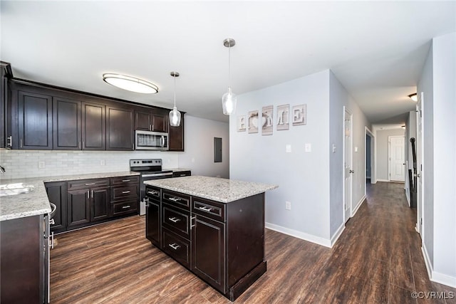 kitchen with a sink, dark wood finished floors, stainless steel appliances, baseboards, and backsplash