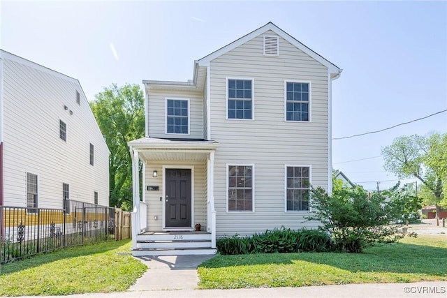 view of front of house with fence and a front lawn