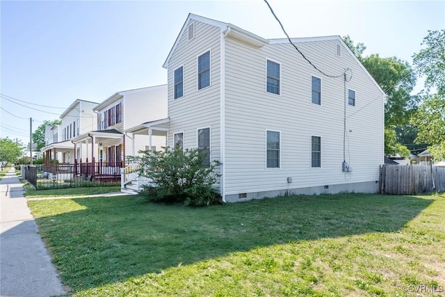 view of home's exterior with fence, a yard, and crawl space
