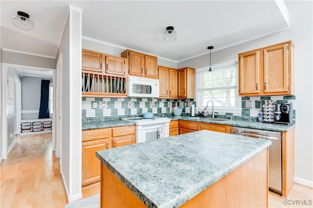 kitchen with a sink, white appliances, ornamental molding, light wood-style flooring, and backsplash